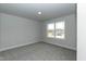 Bright bedroom featuring a view from a large window and grey carpet at 499 Glenkirk Pl # 101, Garner, NC 27529