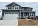 Two-story home with gray siding, white trim, and a three-car garage at 499 Glenkirk Pl # 101, Garner, NC 27529