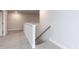 Hallway featuring plush carpeting, white trim, and wooden handrail at 499 Glenkirk Pl # 101, Garner, NC 27529
