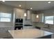 Open kitchen with white cabinetry, stainless steel appliances, and a large central island at 499 Glenkirk Pl # 101, Garner, NC 27529