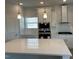 Bright kitchen featuring white cabinets, stainless steel appliances, and a large quartz island at 499 Glenkirk Pl # 101, Garner, NC 27529