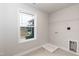 This is a simple laundry room with a shelf and tile floor at 499 Glenkirk Pl # 101, Garner, NC 27529