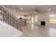 View from the stairs showcases the modern kitchen and open living room with fireplace at 499 Glenkirk Pl # 101, Garner, NC 27529