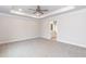 Spacious main bedroom featuring tray ceilings, neutral carpet, and an ensuite bathroom at 499 Glenkirk Pl # 101, Garner, NC 27529