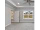 Bright main bedroom featuring plush carpeting, tray ceiling, a ceiling fan, and large windows at 499 Glenkirk Pl # 101, Garner, NC 27529