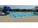 A resort-style swimming pool with a blue water slide, lounge chairs, and clear blue water at 499 Glenkirk Pl # 101, Garner, NC 27529