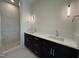 Bathroom features a double vanity with dark cabinets, white countertop and glass enclosed shower at 704 Chatham View Rd # 12, Cary, NC 27511