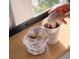 Powdered donuts next to a cup of coffee, with someone dipping a donut in the cup at 704 Chatham View Rd # 12, Cary, NC 27511