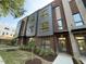 Modern exterior elevation featuring brick, metal panels and lush landscaping at 704 Chatham View Rd # 12, Cary, NC 27511
