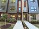Modern townhome with a brick facade, large windows and manicured landscaping at 704 Chatham View Rd # 12, Cary, NC 27511