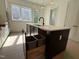 Contemporary kitchen island featuring a sink, stylish faucet, storage, and built-in trash bins at 704 Chatham View Rd # 12, Cary, NC 27511