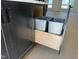 Close-up of a kitchen island with a pull-out double trash can at 704 Chatham View Rd # 12, Cary, NC 27511