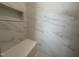Bright shower featuring marble-look tile and a built-in seat for a relaxing experience at 704 Chatham View Rd # 12, Cary, NC 27511