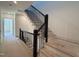 Modern staircase with black railings, hardwood steps, and ample natural light at 704 Chatham View Rd # 12, Cary, NC 27511