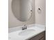 Stylish bathroom features a quartz countertop, brushed silver hardware, and oval mirror at 1125 Brookfield Dr, Gibsonville, NC 27249