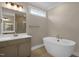 Bathroom with a standalone tub, vanity with white countertop, and walk-in shower at 1125 Brookfield Dr, Gibsonville, NC 27249