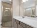 Bathroom featuring walk-in shower with glass door, vanity, and a large mirror at 1125 Brookfield Dr, Gibsonville, NC 27249