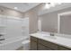 A clean bathroom with a tub-shower combo, a gray vanity, and white countertop at 1125 Brookfield Dr, Gibsonville, NC 27249