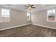 Spacious bedroom with tray ceilings, recessed lighting, and three large windows at 1125 Brookfield Dr, Gibsonville, NC 27249