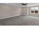 A carpeted bedroom offers a ceiling fan and a bright window at 1125 Brookfield Dr, Gibsonville, NC 27249