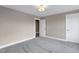 A spacious carpeted bedroom with white trim and doors at 1125 Brookfield Dr, Gibsonville, NC 27249