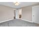 A spacious bedroom boasts neutral tones, soft gray carpet and access to a bathroom at 1125 Brookfield Dr, Gibsonville, NC 27249