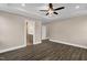 Large bedroom with dark wood flooring, ceiling fan, and bathroom with double vanity at 1125 Brookfield Dr, Gibsonville, NC 27249
