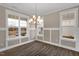 Bright dining room features a modern chandelier, wainscoting, and large windows at 1125 Brookfield Dr, Gibsonville, NC 27249