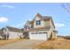 Inviting two-story home featuring a two-car garage, neat landscaping, and a serene suburban setting at 1125 Brookfield Dr, Gibsonville, NC 27249