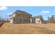 New construction features a large backyard, siding, windows, and construction debris at 1125 Brookfield Dr, Gibsonville, NC 27249