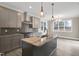 Chic kitchen boasting an island with a sink, granite countertops, and a stainless steel range at 1125 Brookfield Dr, Gibsonville, NC 27249