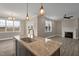 Elegant kitchen featuring island seating, a stainless steel sink, and hardwood floors at 1125 Brookfield Dr, Gibsonville, NC 27249
