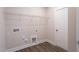 Bright laundry room featuring wood-look floors, washer and dryer hookups, and a wire shelf for storage at 1125 Brookfield Dr, Gibsonville, NC 27249