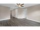 Open living room featuring ceiling fan, dark wood flooring, and several entrances at 1125 Brookfield Dr, Gibsonville, NC 27249
