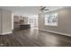 Bright living room featuring dark wood flooring and a large window letting in natural light at 1125 Brookfield Dr, Gibsonville, NC 27249