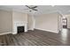Spacious living room with modern fireplace, ceiling fan, hardwood floors, and backyard access at 1125 Brookfield Dr, Gibsonville, NC 27249