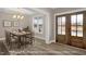 Elegant dining room featuring a modern table and chairs set, chandelier, and natural light at 1129 Brookfield Dr, Gibsonville, NC 27249
