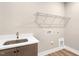Bright laundry room with a stainless sink, white countertop, and wire shelving at 1129 Brookfield Dr, Gibsonville, NC 27249