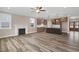 Open-concept living room with fireplace, ceiling fan, and access to the kitchen at 1129 Brookfield Dr, Gibsonville, NC 27249