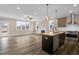 Open concept living room and kitchen with fireplace, stainless appliances, and natural light at 1129 Brookfield Dr, Gibsonville, NC 27249