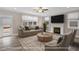 Bright living room featuring a fireplace, large windows, and a comfortable seating arrangement at 1129 Brookfield Dr, Gibsonville, NC 27249