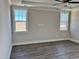 Spacious main bedroom with hardwood floors, tray ceiling, and bright windows at 1125 Brookfield Dr, Gibsonville, NC 27249