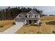 New construction home featuring a two-car garage and a well-manicured lawn at 1129 Brookfield Dr, Gibsonville, NC 27249