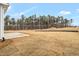 Large backyard is mainly lawn, and has a concrete area and some trees in the background at 1129 Brookfield Dr, Gibsonville, NC 27249