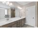 Bathroom with double sink vanity, white countertop, decorative mirror and lighting at 1129 Brookfield Dr, Gibsonville, NC 27249