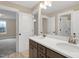 Bathroom featuring a double vanity with framed mirrors and tile flooring at 1129 Brookfield Dr, Gibsonville, NC 27249