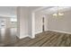 Open concept dining room featuring hardwood floors, modern lighting, and a neutral color palette at 1129 Brookfield Dr, Gibsonville, NC 27249