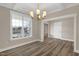 Dining room featuring a decorative light fixture and large windows with beautiful trim at 1129 Brookfield Dr, Gibsonville, NC 27249
