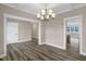 Dining room boasting a decorative light fixture and transitions into the kitchen at 1129 Brookfield Dr, Gibsonville, NC 27249