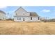 The backyard features a lawn that leads up to a two-story house with gray siding at 1129 Brookfield Dr, Gibsonville, NC 27249